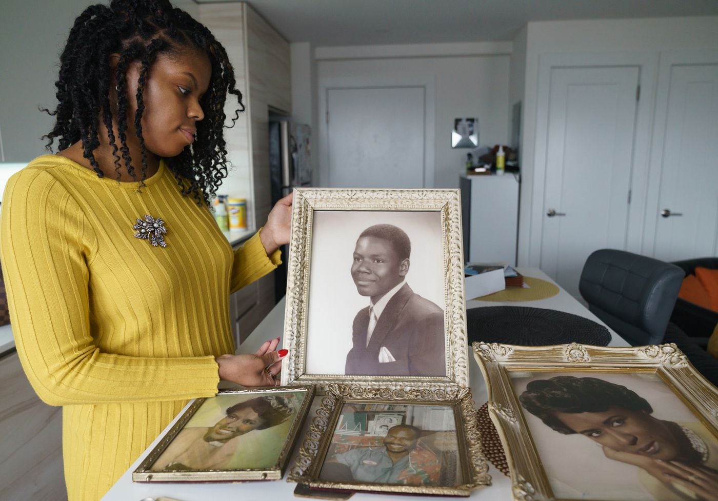 Vaneeda Days, the great-niece of Dorothy Beam, holds a photograph of Joseph Beam, who was a trailblazing black gay author from Philadelphia.