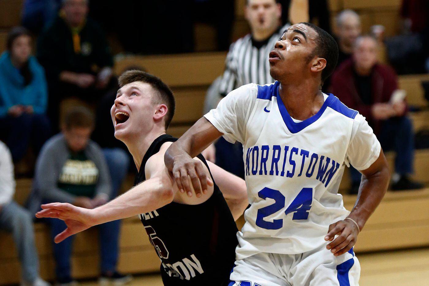 Nazir Kinney (right) of Norristown battles for rebound position with Theo Henry of Lower Merion in the fourth quarter.