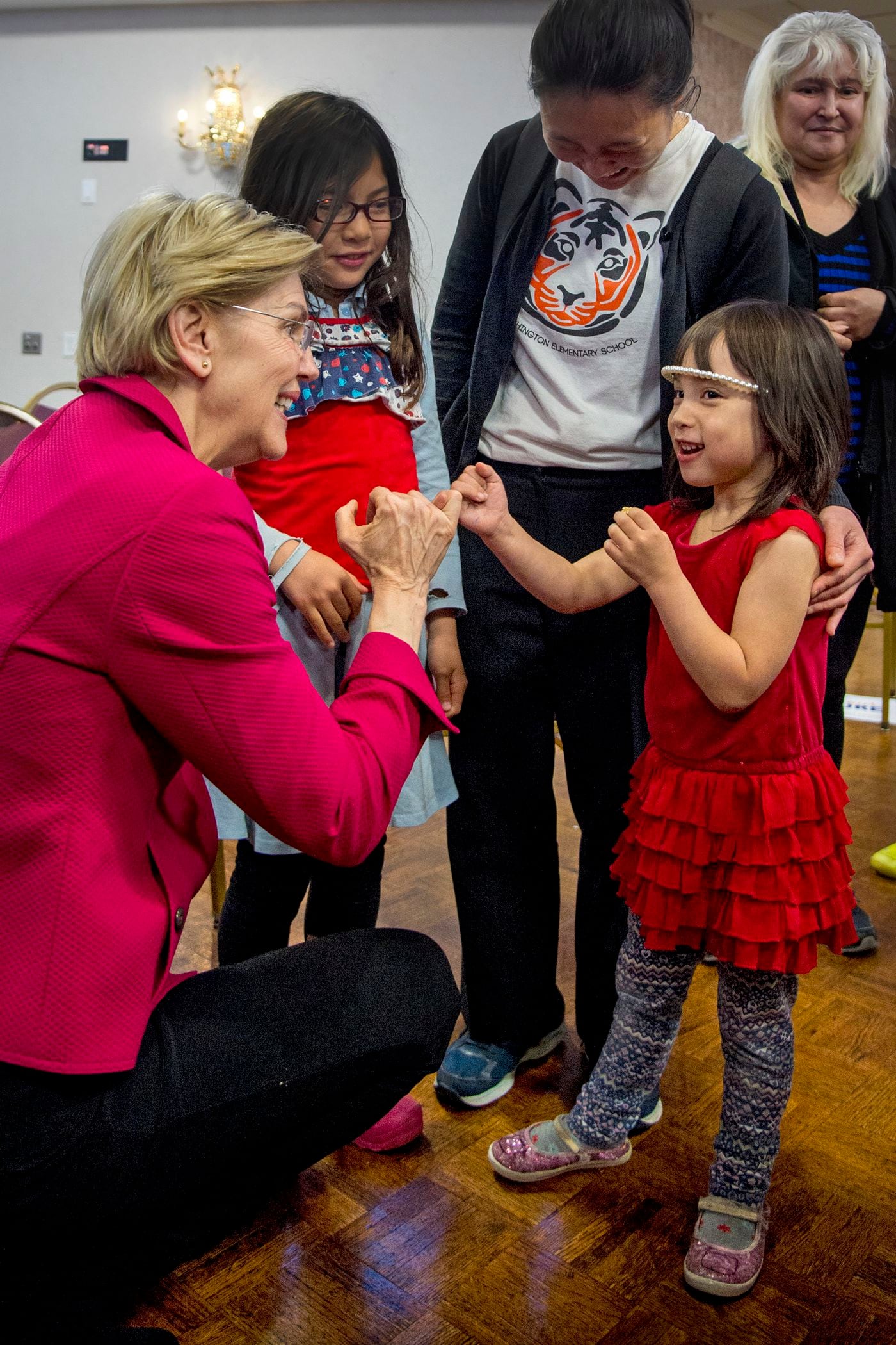 Democratic presidential candidate Sen. Elizabeth Warren gets on her knees to "pinky swear" with five year old Sarah Buse-Morley saying "that's what girls do," when talking about running for president, following a meeting with members of the American Federation of Teachers, at the Plumbers Local 690 Union Hall in Northeast Philadelphia May 13, 2019. Sarah's mom, Meredith Buse (rear) teaches first grade at Vare-Washington Elementary School. Her other daughter is Rebecca Buse-Morley (rear, left), 8.