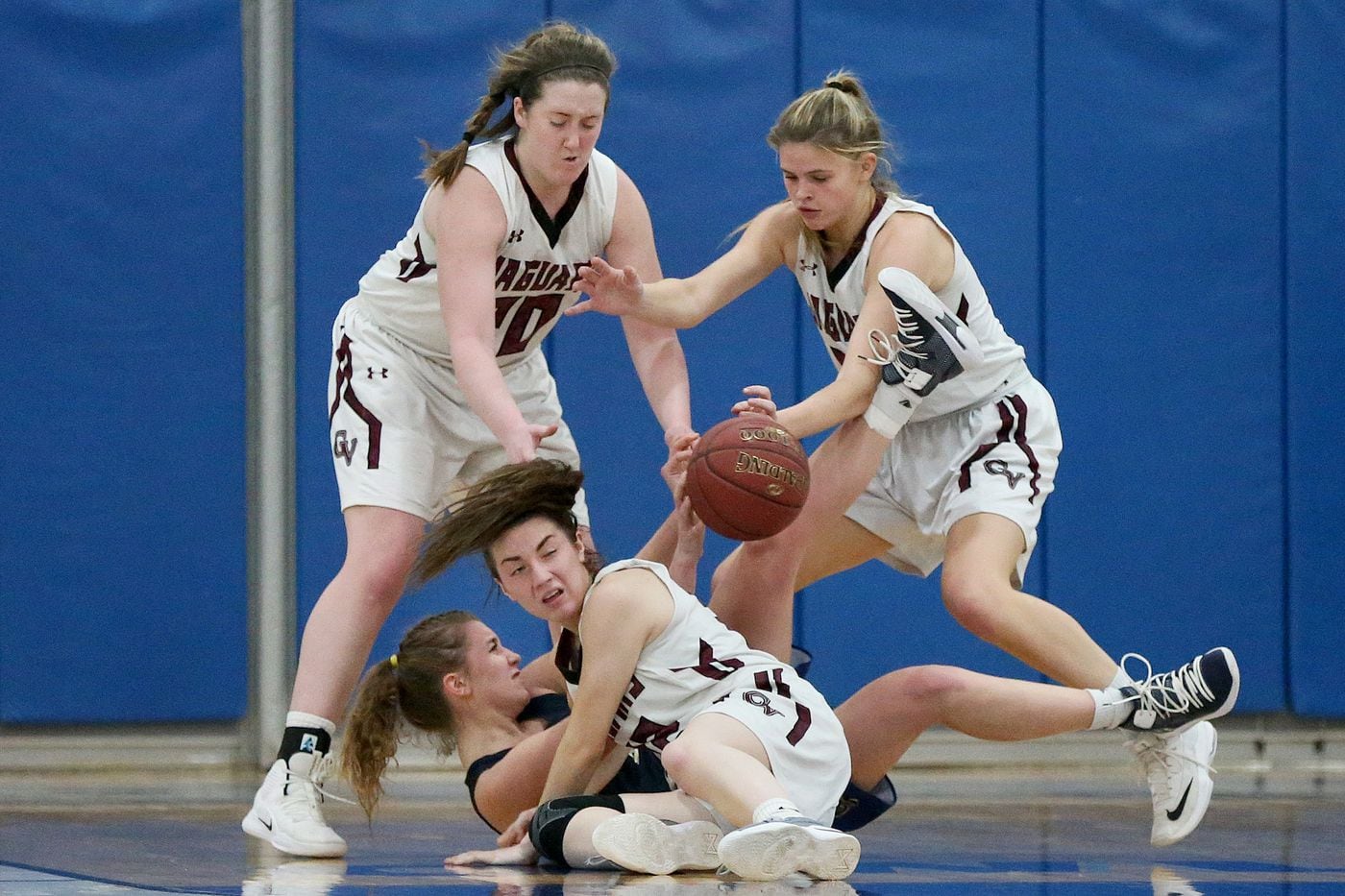 Garnet Valley's Emily McAteer (left), Madi McKee (center, on floor) and Jillian Nagy defend as Spring-Ford's Olivia Olsen tries to throw a pass. 