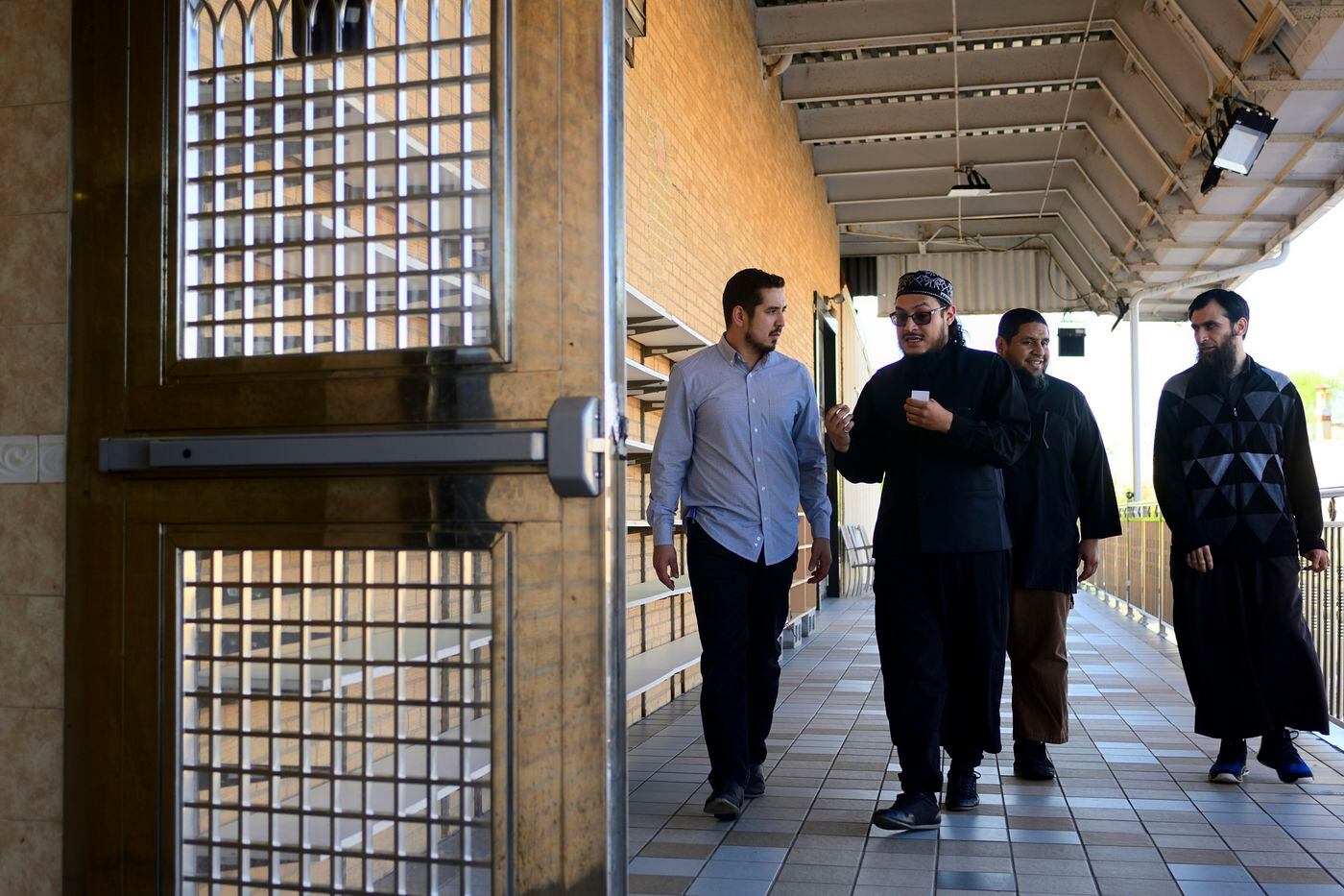 From left to right: Jalil Navarro, Ahmad Jose, and Imam Isa Parada (the fourth man is unidentified) are heading in for the afternoon prayer at Masjid al-Hidaya mosque, in North Philadelphia.